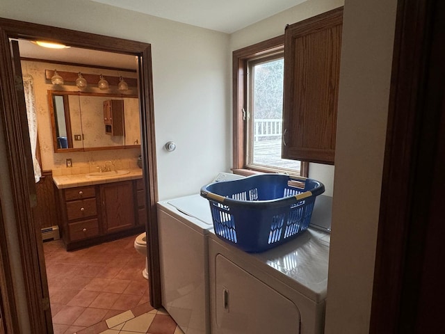 laundry area featuring cabinets, sink, light tile patterned floors, independent washer and dryer, and a baseboard radiator