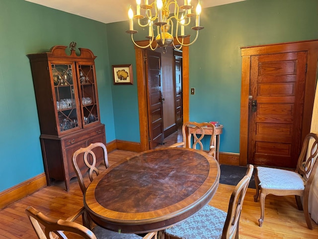 dining room featuring an inviting chandelier and light hardwood / wood-style flooring