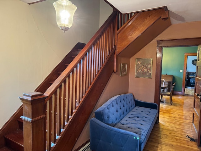 staircase featuring wood-type flooring and vaulted ceiling