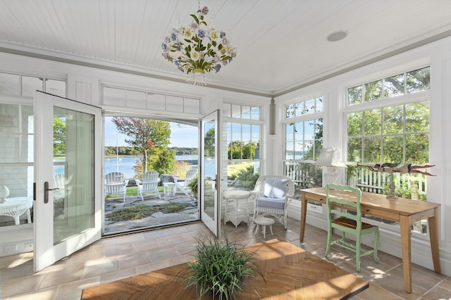 sunroom / solarium with french doors and a water view