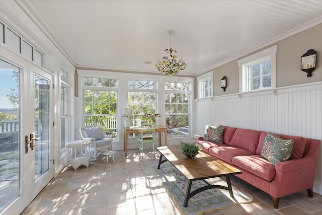 sunroom with a chandelier, french doors, and a healthy amount of sunlight