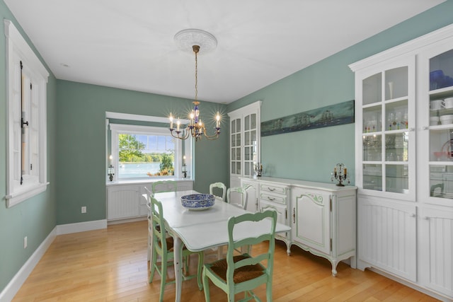 dining space featuring a chandelier and light hardwood / wood-style floors