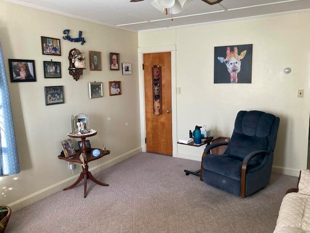 sitting room with ceiling fan, carpet, and ornamental molding