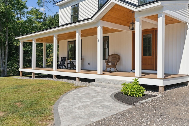 view of exterior entry featuring a lawn