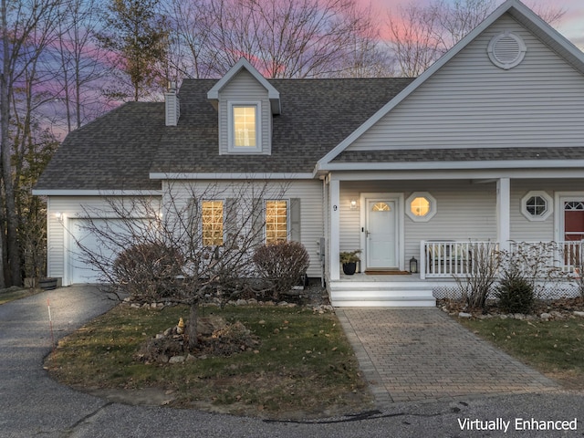 view of front of property with a porch and a garage