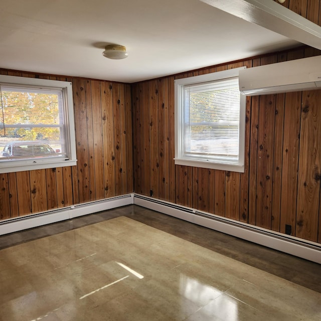 empty room with an AC wall unit, a wealth of natural light, and wooden walls