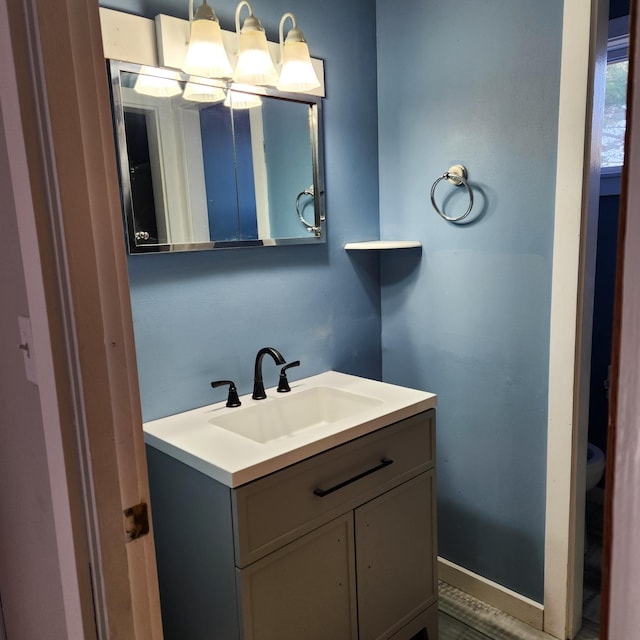 bathroom with vanity, hardwood / wood-style flooring, and toilet