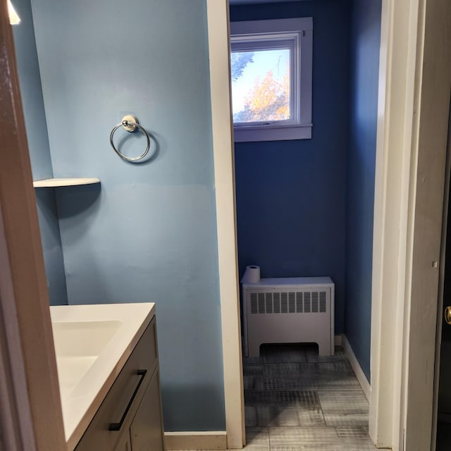 bathroom with vanity, radiator heating unit, and tile patterned floors