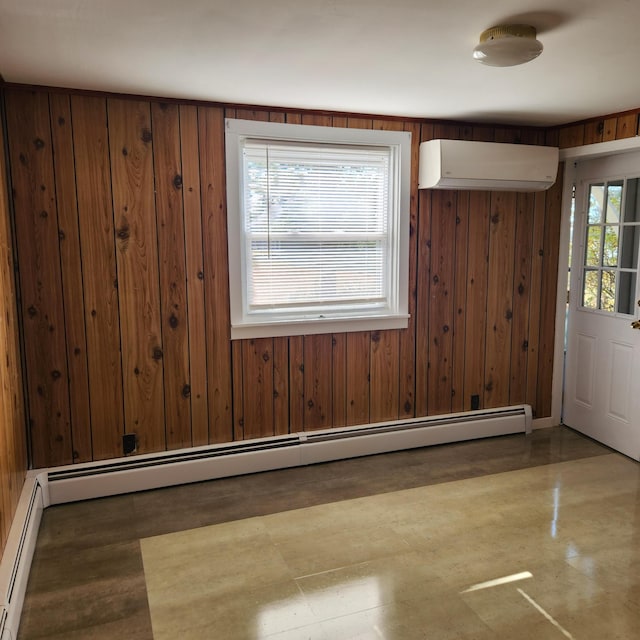 interior space with wood walls, a wall mounted AC, a baseboard radiator, and a wealth of natural light