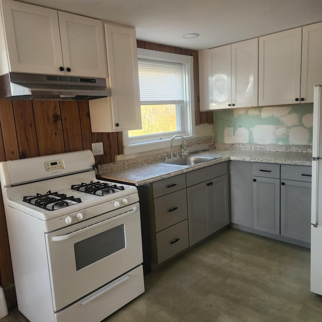 kitchen with white range with gas cooktop, white cabinetry, sink, and backsplash