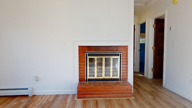 details featuring hardwood / wood-style floors, baseboard heating, and a fireplace