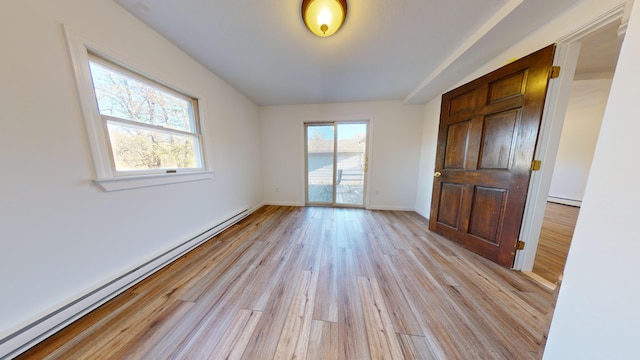 spare room featuring light hardwood / wood-style flooring and a baseboard radiator