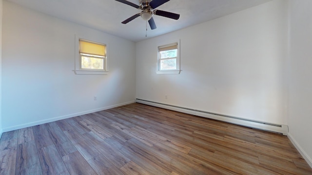 spare room featuring light hardwood / wood-style floors, a baseboard radiator, and ceiling fan