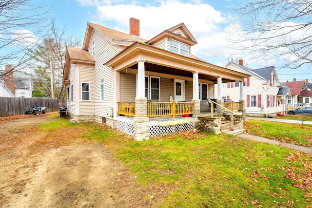 view of front of home with a front yard and covered porch