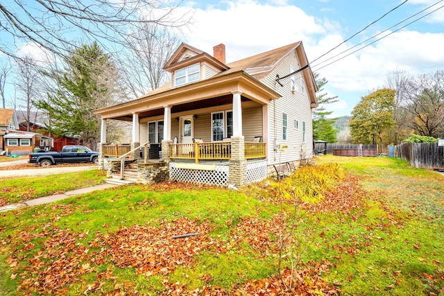 view of front of home featuring a front lawn and covered porch