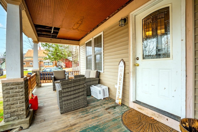 deck featuring a porch and an outdoor hangout area