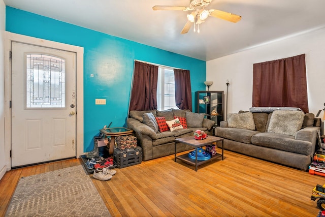 living room with light hardwood / wood-style flooring and ceiling fan