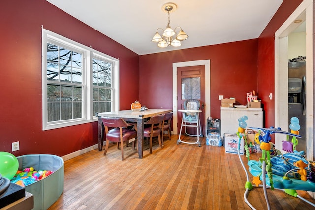 dining room featuring light hardwood / wood-style flooring and a notable chandelier