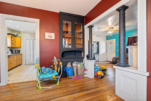 interior space with ceiling fan and light hardwood / wood-style floors