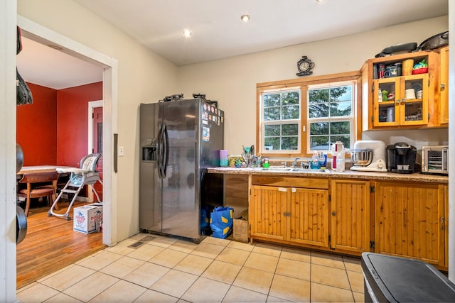 kitchen featuring light hardwood / wood-style flooring, sink, and stainless steel fridge with ice dispenser