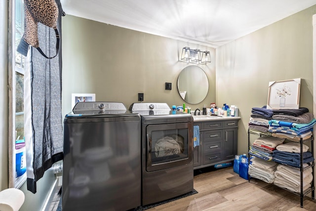 bathroom with vanity, washing machine and clothes dryer, and wood-type flooring