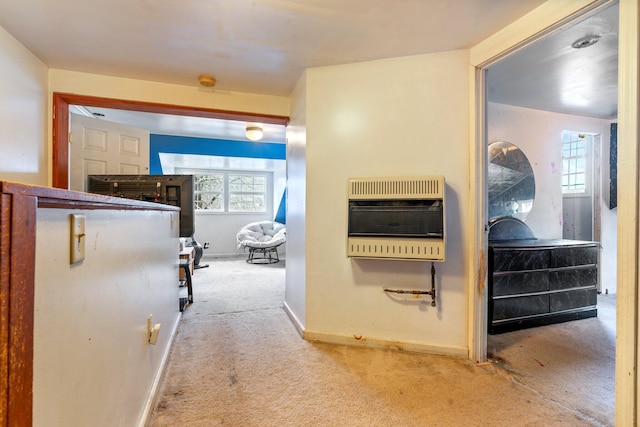 corridor with heating unit and light carpet