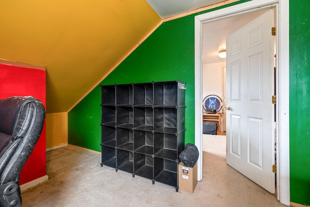 bonus room featuring lofted ceiling and carpet