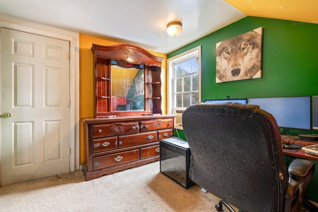 carpeted office featuring vaulted ceiling