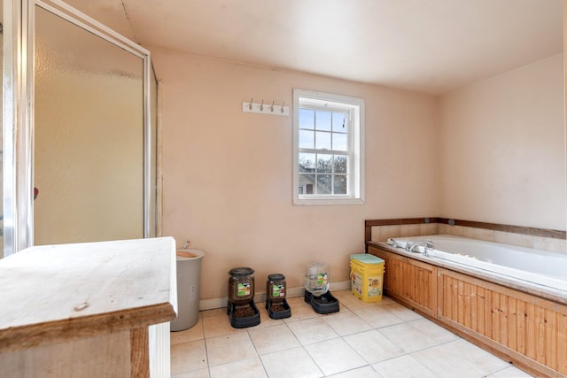 bathroom with separate shower and tub and tile patterned floors