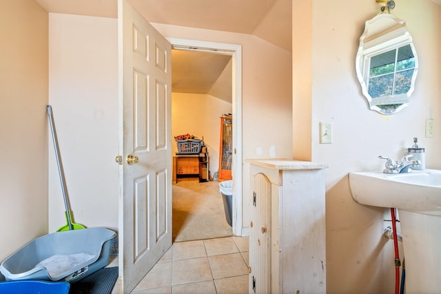 bathroom featuring tile patterned floors and vaulted ceiling