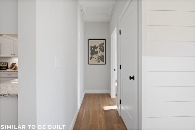 hallway with hardwood / wood-style floors