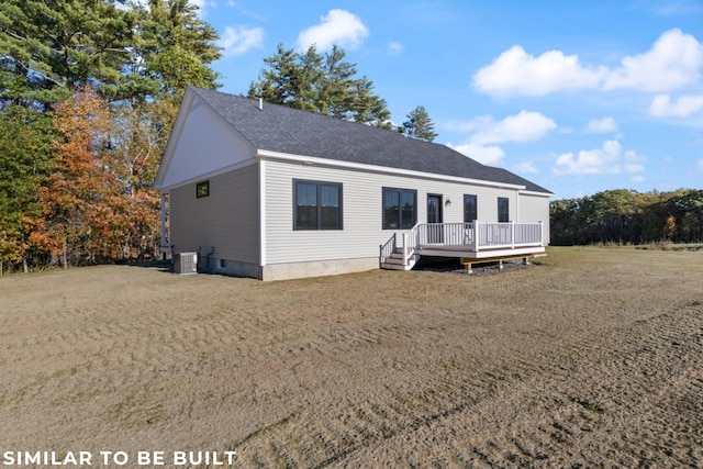 view of front of home featuring a front yard, a deck, and central AC unit