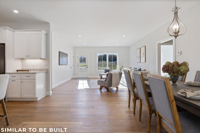 dining space with light hardwood / wood-style flooring