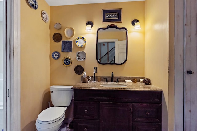 bathroom with toilet and vanity