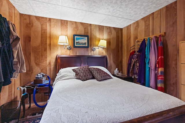 bedroom featuring wood walls