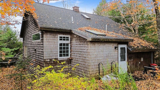 88 Piddock Ln, Fayette, ME 04349 - view of property exterior featuring roof with shingles and a chimney