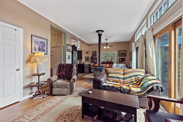 88 Piddock Ln, Fayette, ME 04349 - living room featuring a wood stove, wood finished floors, and a ceiling fan