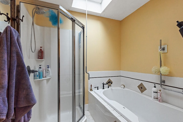 bathroom featuring separate shower and tub and a skylight