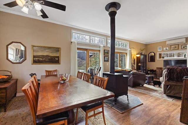 88 Piddock Ln, Fayette, ME 04349 - dining room with a wall unit AC, plenty of natural light, wood finished floors, crown molding, and a ceiling fan