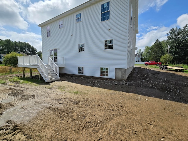 rear view of property with a wooden deck