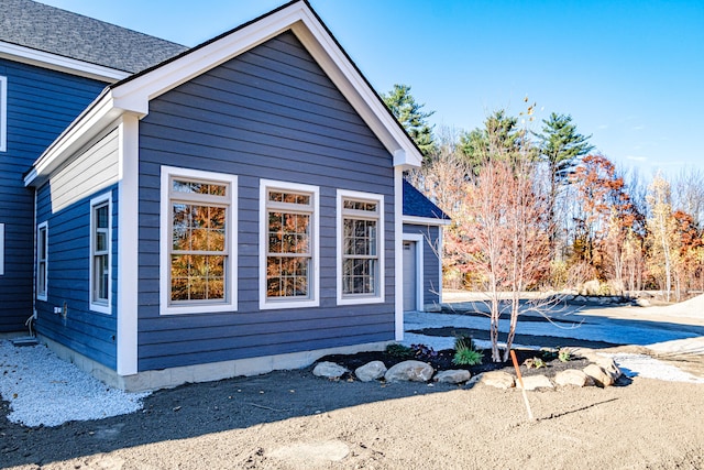 view of side of home with a garage