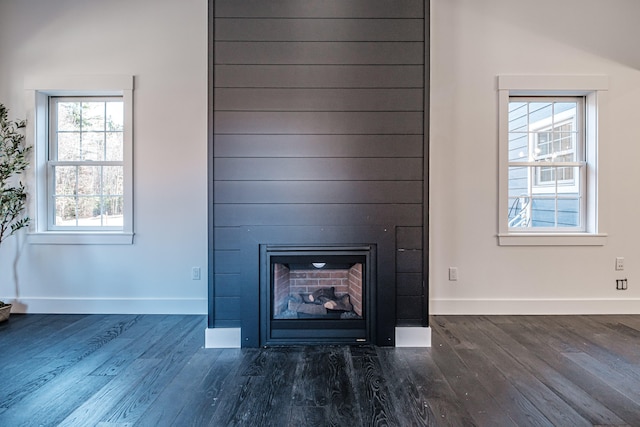 interior details featuring hardwood / wood-style flooring and a large fireplace