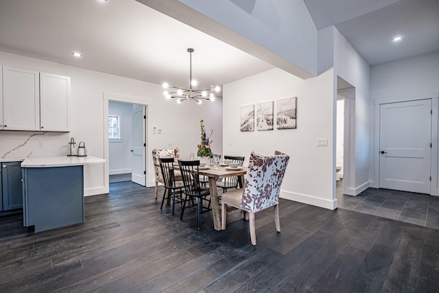 dining space with dark hardwood / wood-style floors and an inviting chandelier