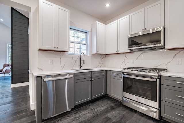 kitchen featuring dark hardwood / wood-style floors, sink, white cabinetry, gray cabinets, and appliances with stainless steel finishes