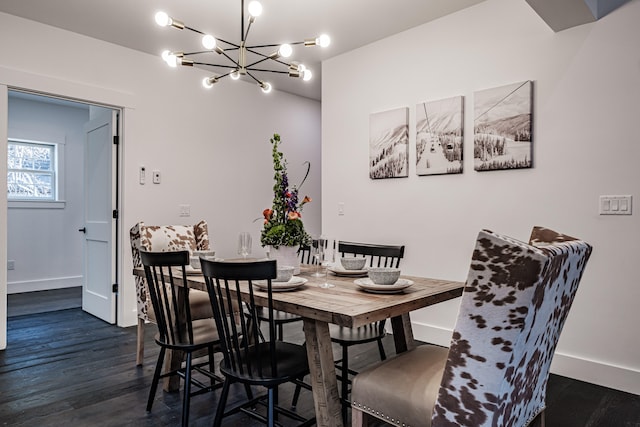 dining room with a notable chandelier and dark hardwood / wood-style flooring