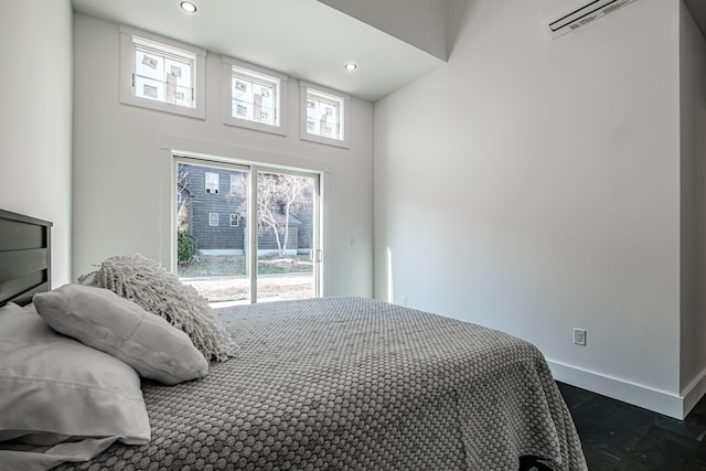 bedroom featuring an AC wall unit and a high ceiling