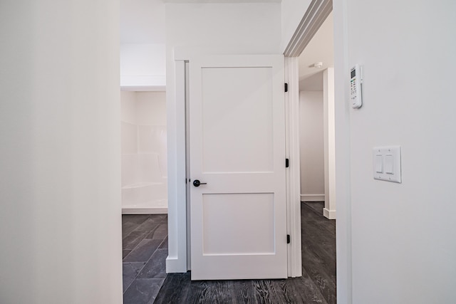 hallway with dark hardwood / wood-style flooring