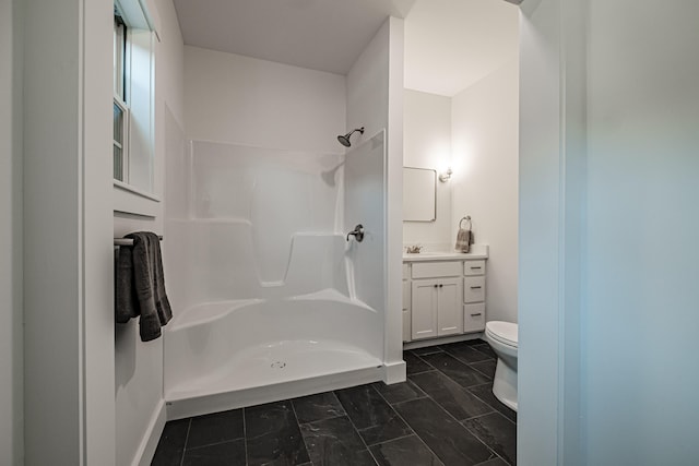 bathroom with vanity, toilet, and walk in shower