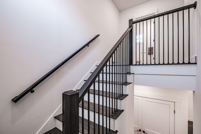 stairway with hardwood / wood-style floors