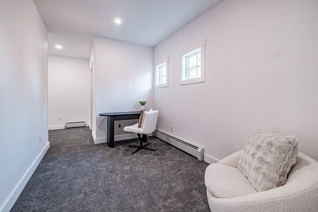 office area with baseboard heating and dark colored carpet